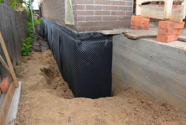 Happy homeowners after waterproofing job in Newton